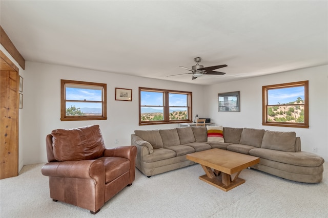 carpeted living room with ceiling fan