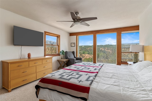 bedroom featuring ceiling fan and light colored carpet