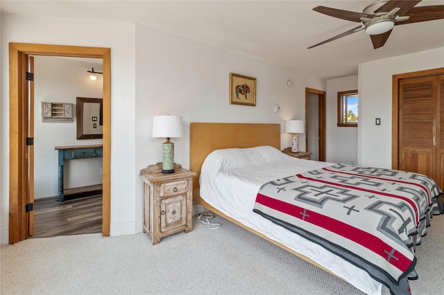 carpeted bedroom with a ceiling fan and a closet