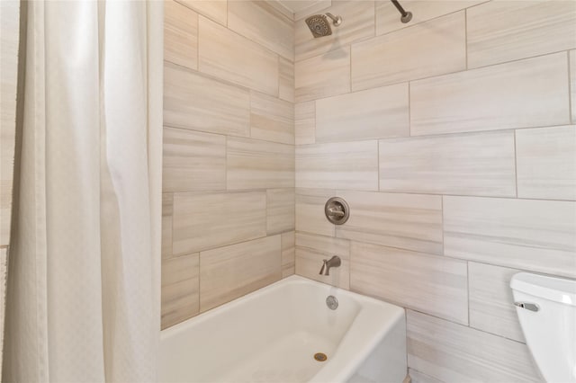 bathroom with toilet and shower / bathtub combination with curtain