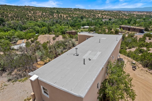 drone / aerial view featuring a mountain view and a forest view