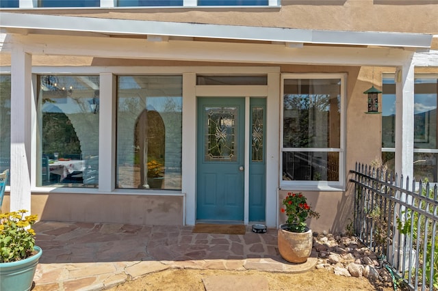 property entrance with stucco siding