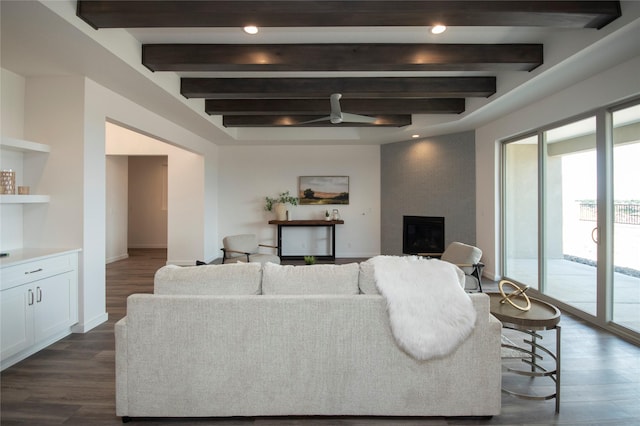 living room featuring a fireplace, dark hardwood / wood-style floors, and beamed ceiling