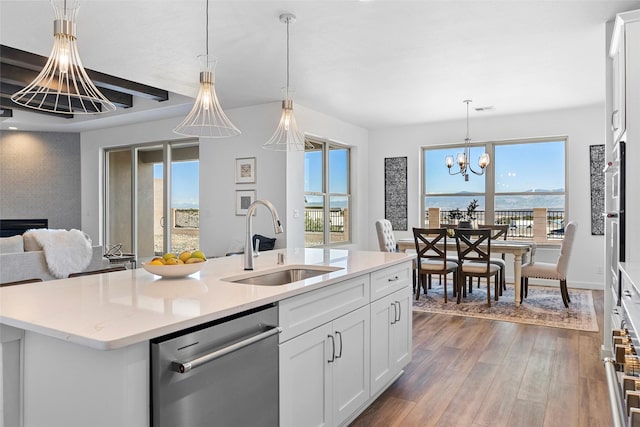 kitchen with sink, dishwasher, white cabinetry, a water view, and a center island with sink