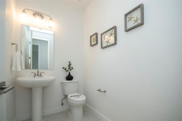 bathroom featuring sink and toilet