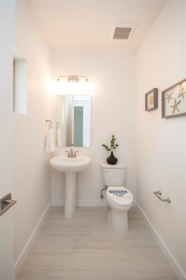 bathroom featuring sink and toilet