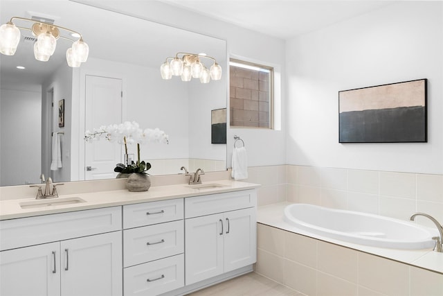 bathroom with vanity and a relaxing tiled tub