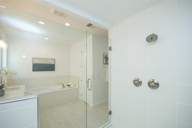 bathroom with shower with separate bathtub