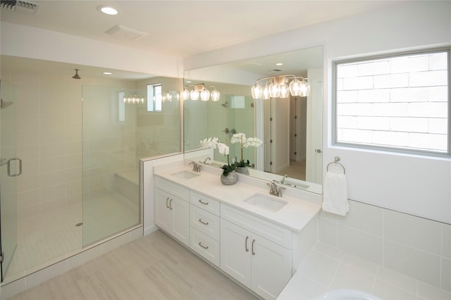 bathroom featuring vanity and a shower with shower door