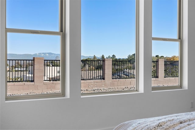 unfurnished bedroom with a mountain view and multiple windows