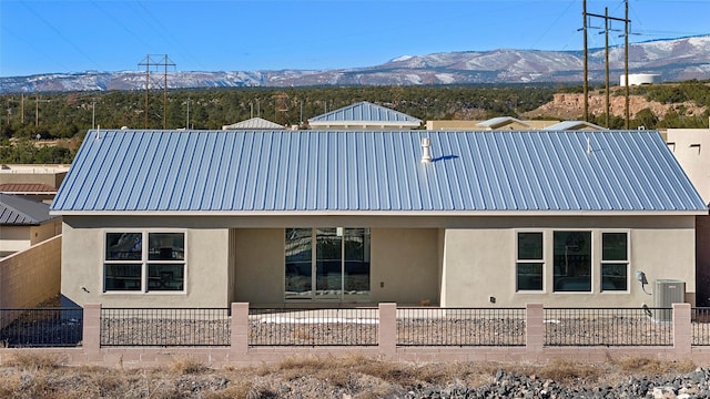 back of property featuring central AC and a mountain view