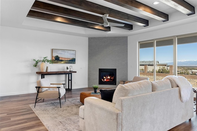 living room with ceiling fan, a fireplace, and dark hardwood / wood-style flooring