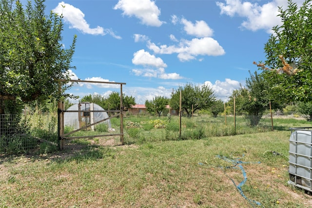 view of yard with fence and an outbuilding