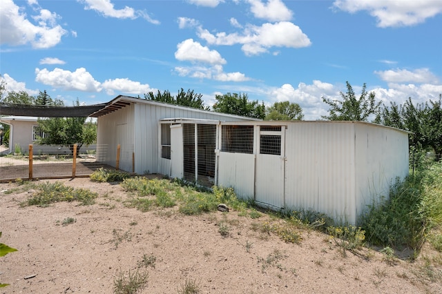 rear view of house with an outdoor structure