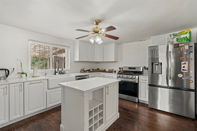 kitchen featuring dark hardwood / wood-style flooring, white cabinetry, sink, and stainless steel appliances