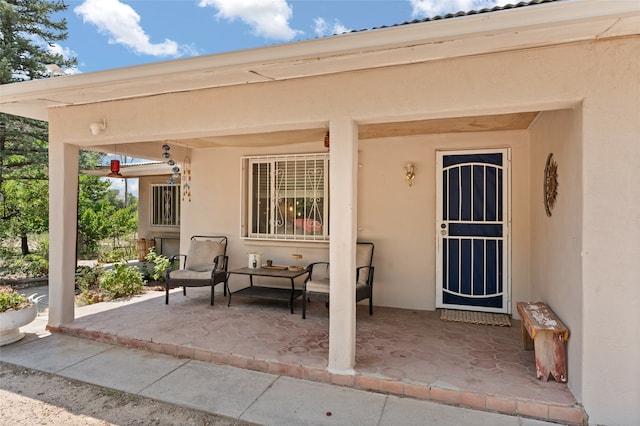 doorway to property with a patio area and stucco siding