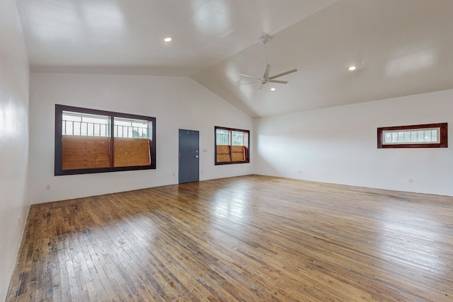 unfurnished room with hardwood / wood-style flooring, high vaulted ceiling, and a ceiling fan