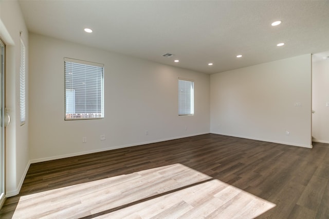 spare room featuring dark hardwood / wood-style floors