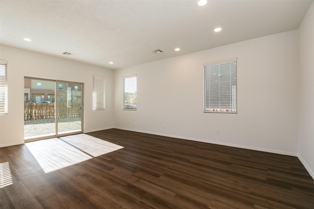 empty room with dark hardwood / wood-style floors