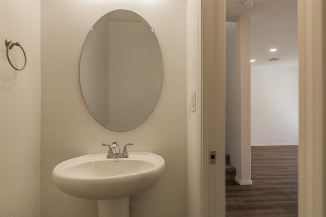 bathroom with hardwood / wood-style flooring and sink