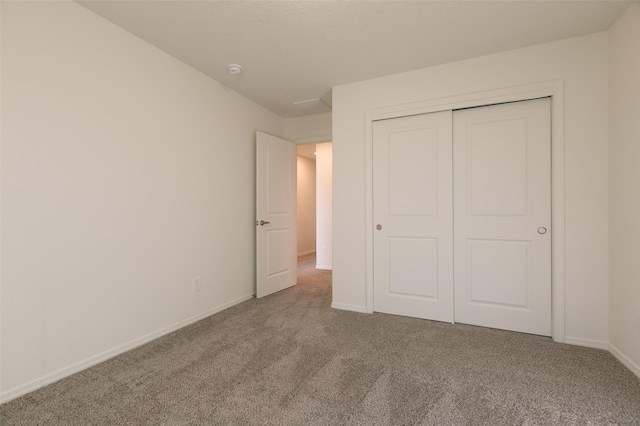 unfurnished bedroom with a closet and carpet