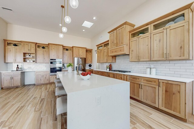 unfurnished living room with ceiling fan and light wood-type flooring