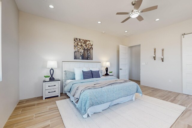 kitchen with ceiling fan, stainless steel appliances, sink, hanging light fixtures, and a spacious island