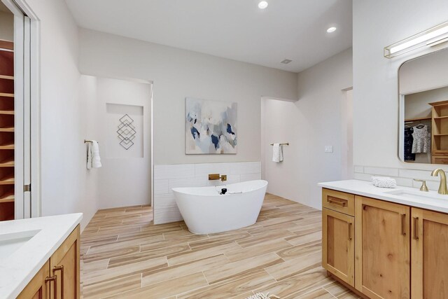 bathroom with tasteful backsplash and vanity