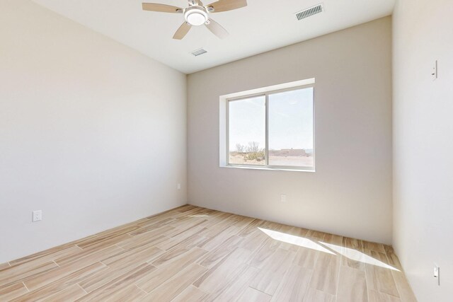 unfurnished room with ceiling fan and light hardwood / wood-style floors