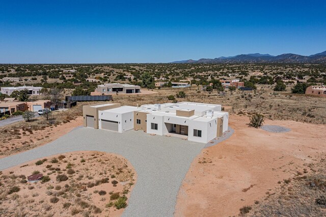 southwest-style home featuring a garage and a mountain view