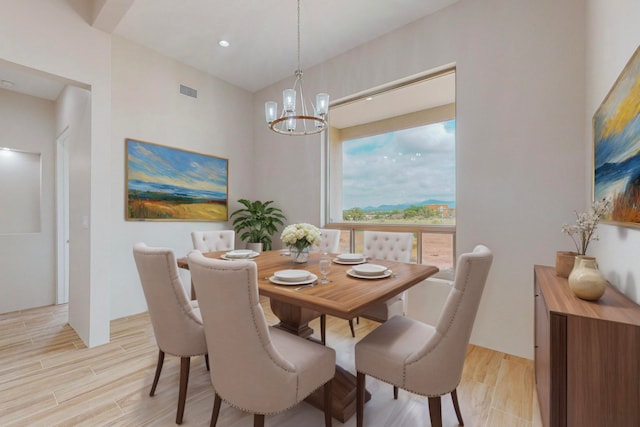 dining area featuring an inviting chandelier and light hardwood / wood-style flooring