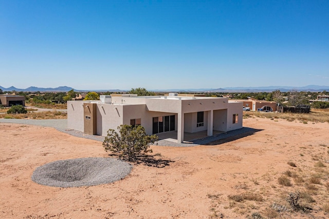 back of house with a mountain view