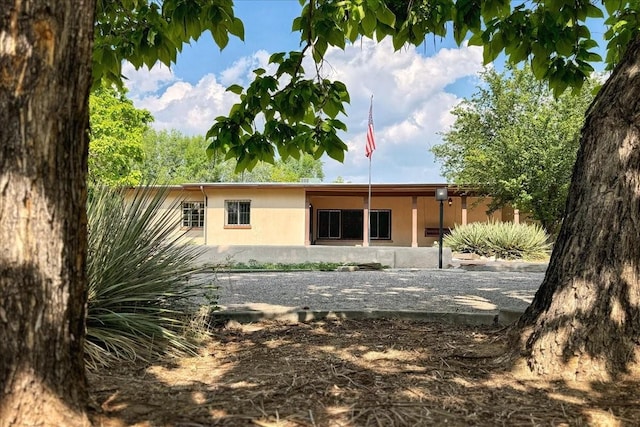 rear view of property with stucco siding