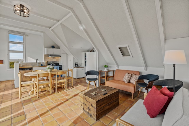 tiled living room featuring lofted ceiling, sink, and a textured ceiling