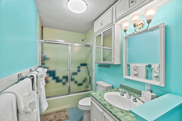 full bathroom with combined bath / shower with glass door, tile patterned flooring, a textured ceiling, toilet, and vanity