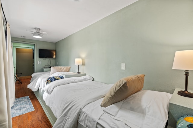 bedroom featuring ceiling fan and dark hardwood / wood-style flooring