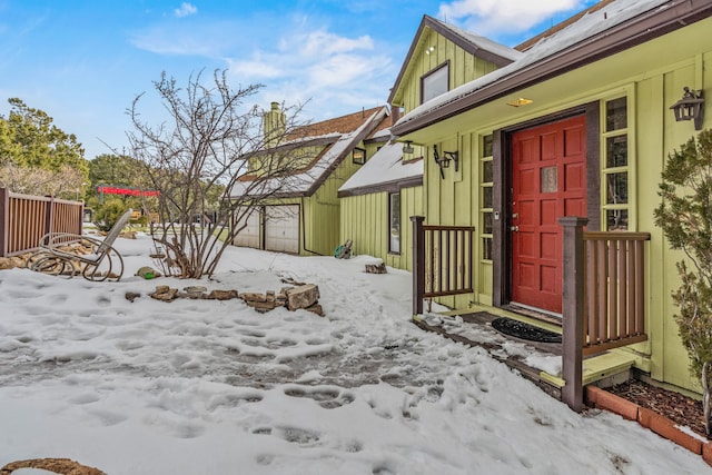 view of snow covered property entrance