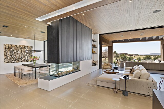 living room with light tile patterned floors, wood ceiling, and expansive windows