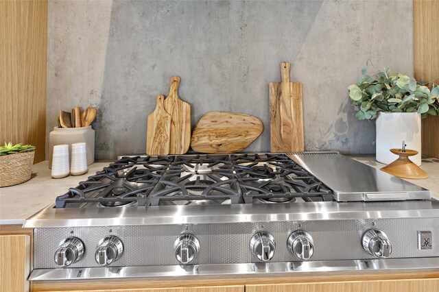 room details featuring stainless steel gas stovetop and light brown cabinets