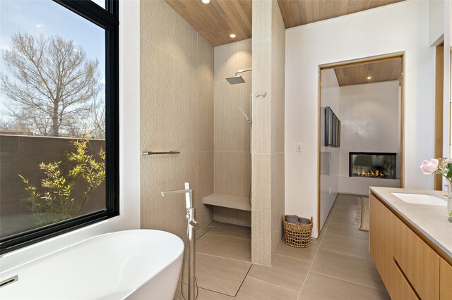 bathroom with wood ceiling, tile patterned flooring, vanity, a wealth of natural light, and shower with separate bathtub