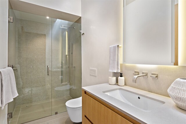 bathroom featuring walk in shower, vanity, and toilet