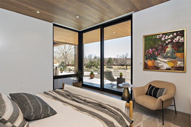 bedroom with wood ceiling, a wall of windows, and access to outside