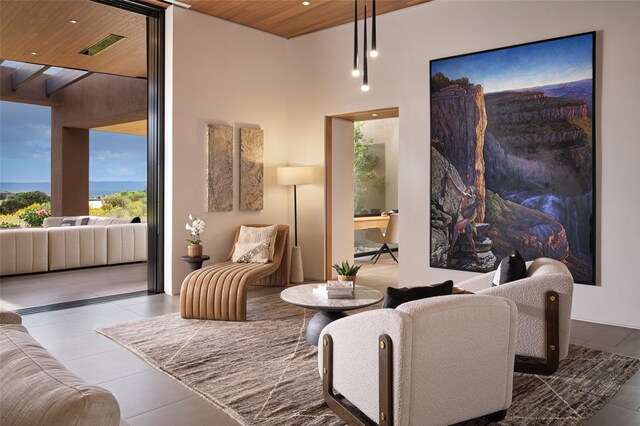 sitting room with tile patterned flooring and wooden ceiling