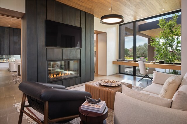 tiled living room with expansive windows, a fireplace, and wood ceiling