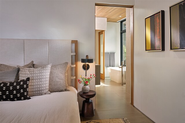 bedroom featuring wooden ceiling and floor to ceiling windows