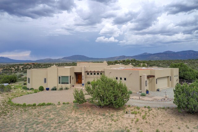 view of front of property with a garage and a mountain view