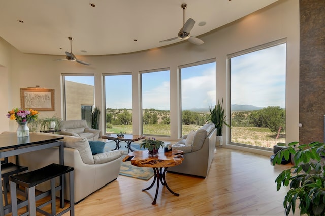 living room featuring ceiling fan and light hardwood / wood-style floors