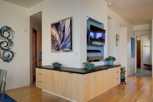 hallway with light hardwood / wood-style flooring