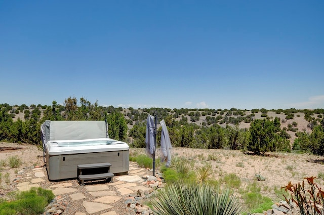 view of patio / terrace with a hot tub