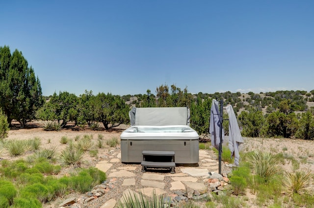 exterior space with a hot tub